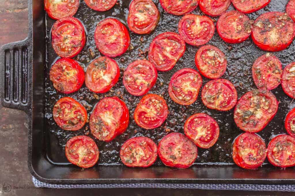 Tomatoes roasted in oven placed in cast iron pan