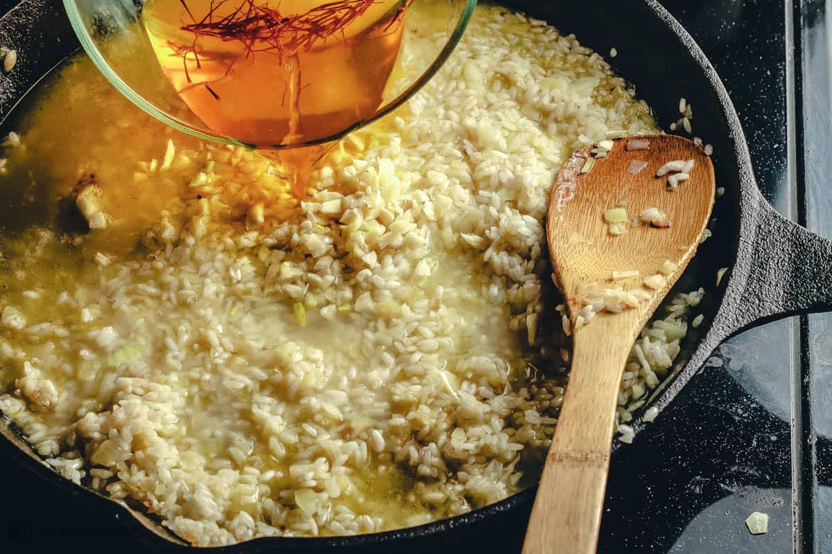 Cast iron skillet with rice being cooked