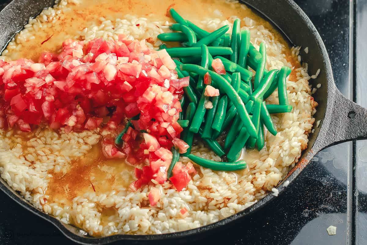  Tomatoes and green beans added to paella rice