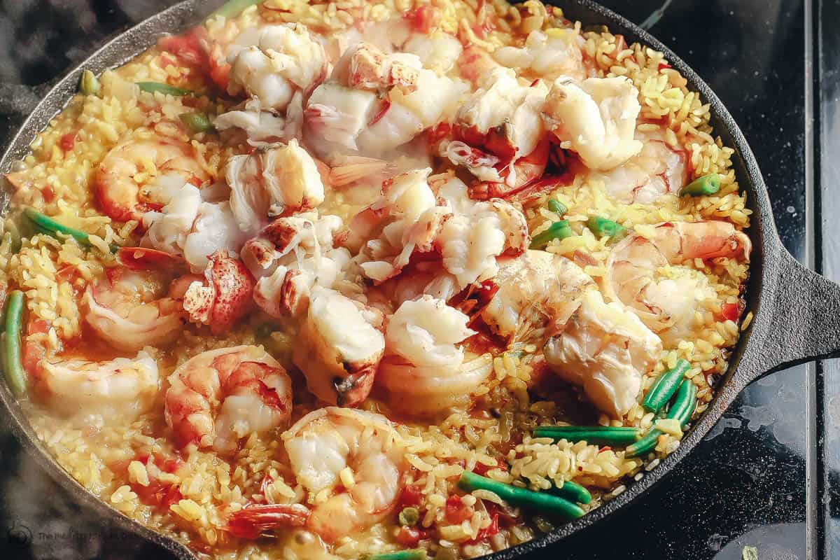 Seafood paella cooked in cast iron skillet