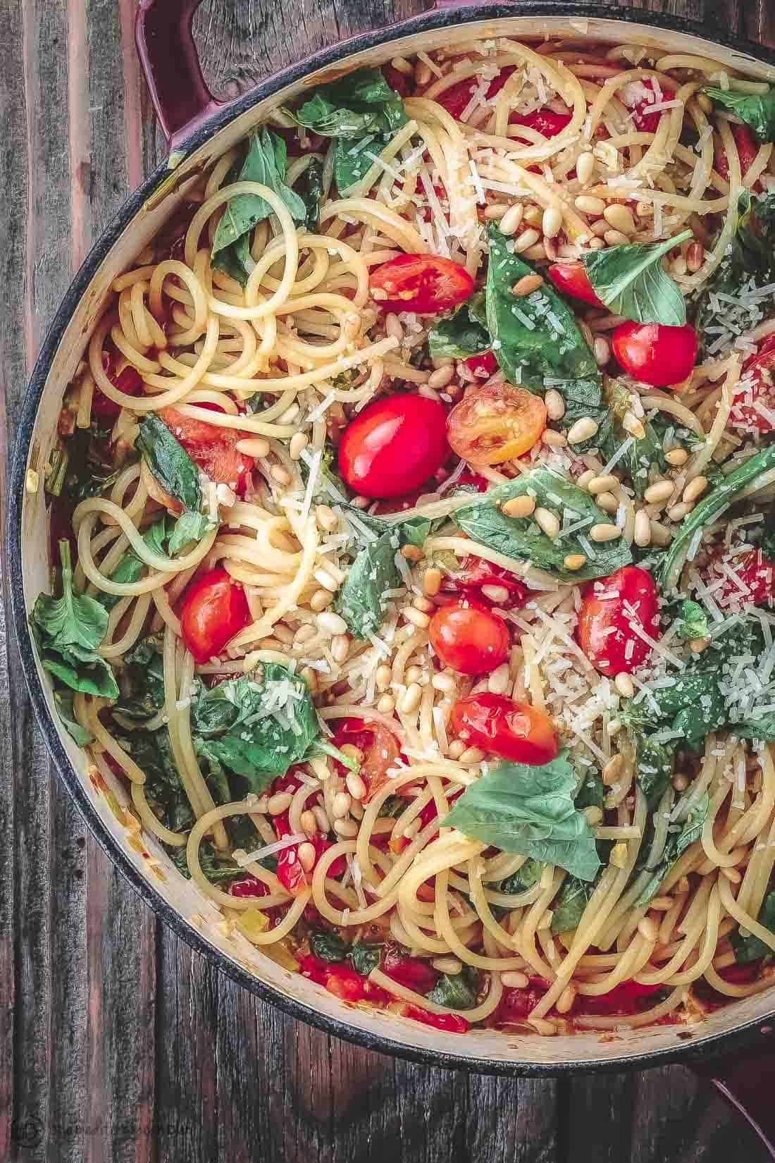 Spaghetti with tomatoes, basil, pine nuts and Parmesan in a large pot