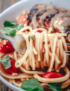 Spaghetti twirled on a fork from a bowl