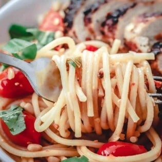 Spaghetti twirled on a fork from a bowl