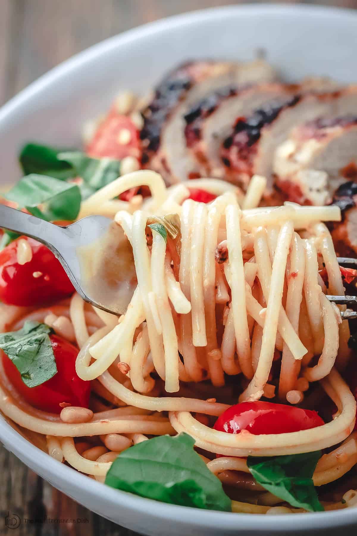 Spaghetti twirled on a fork from a bowl