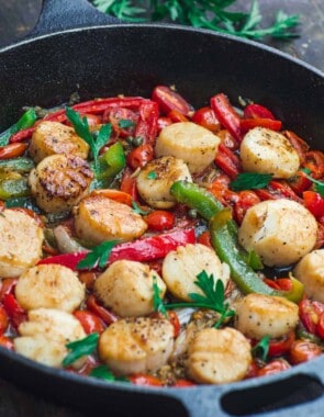 Scallops with vegetables in a cast iron skillet