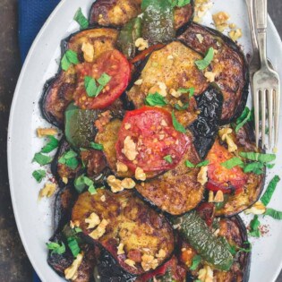 Slices of fried eggplant and vegetables served on a plate