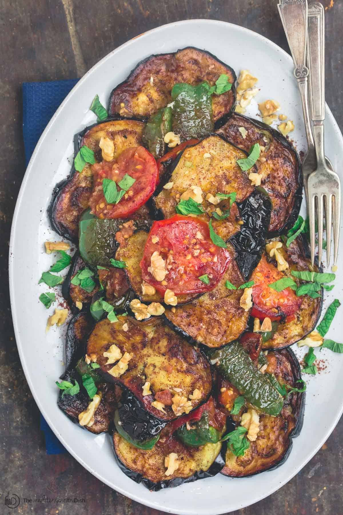 Slices of fried eggplant and vegetables served on a plate