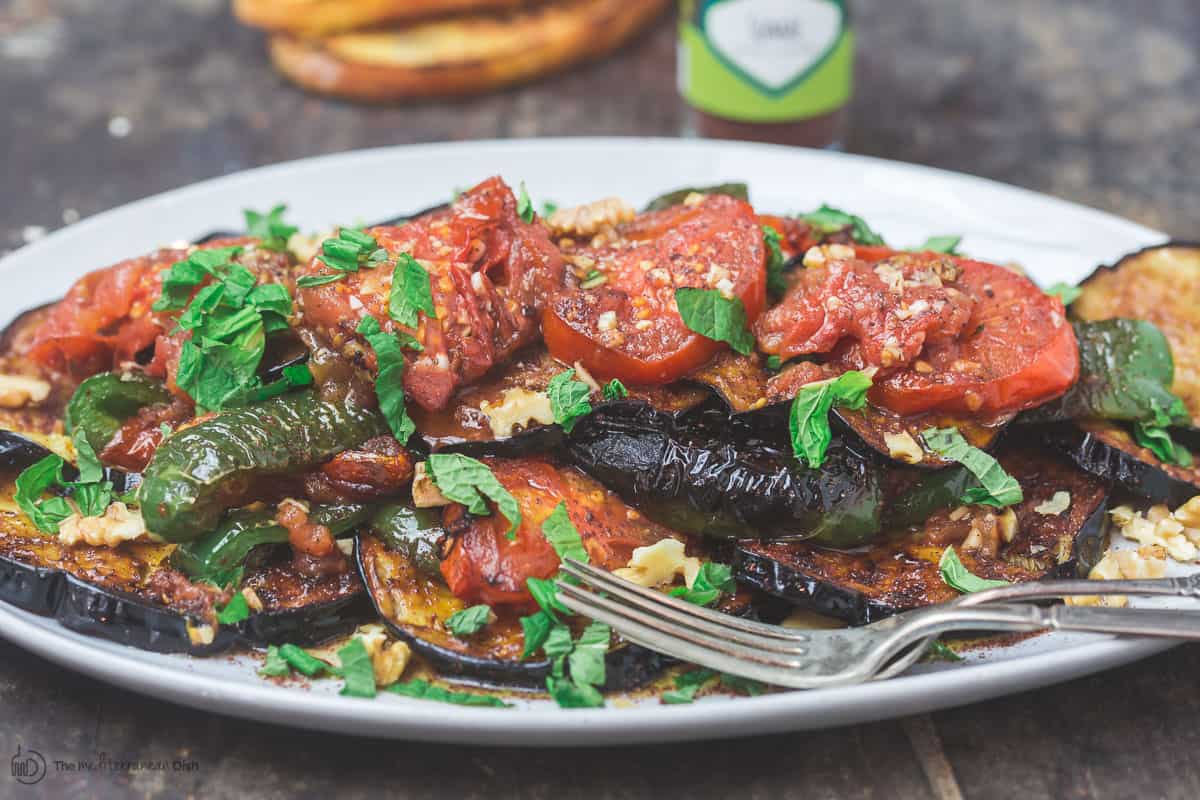 Slices of fried eggplant and vegetables served on a plate