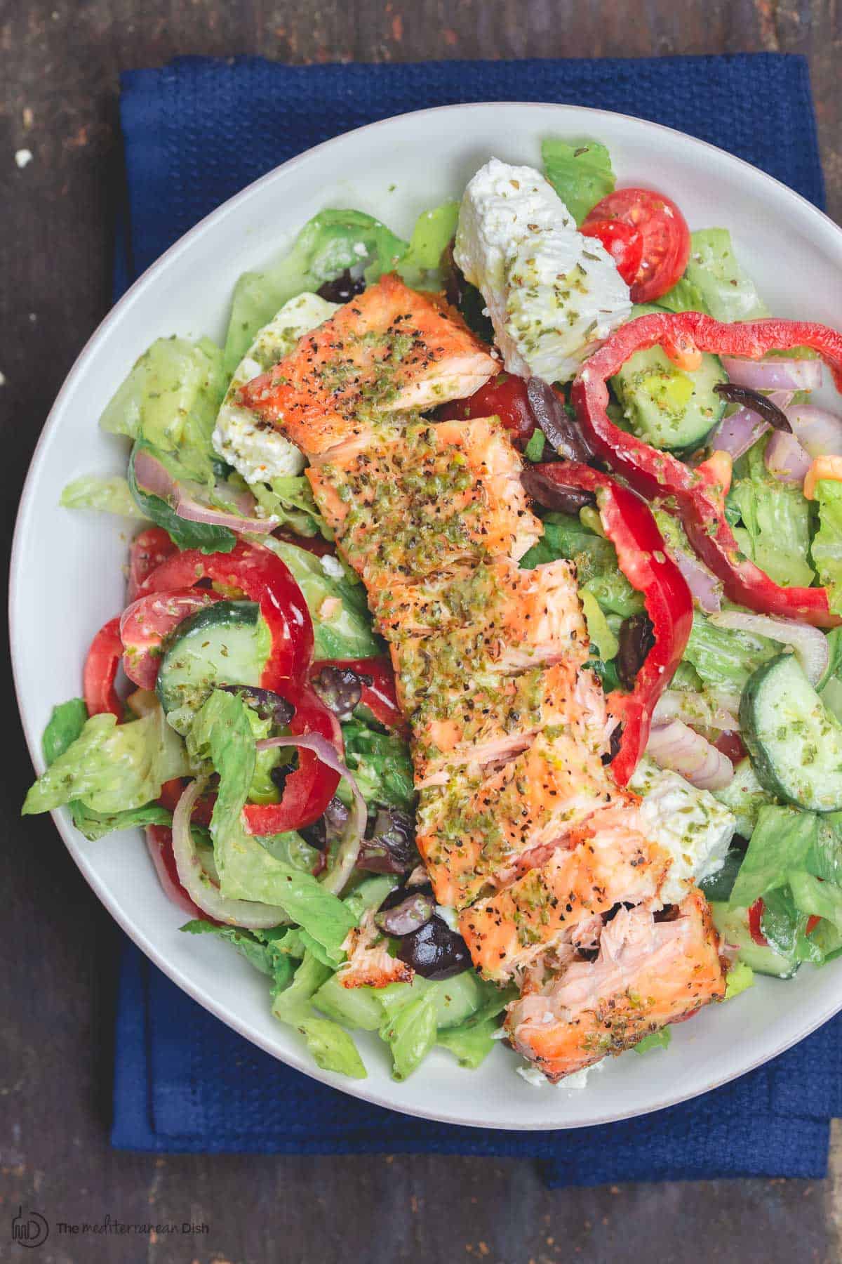 Salmon served on top of salad in a bowl