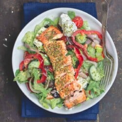 Salmon served on top of salad in a bowl