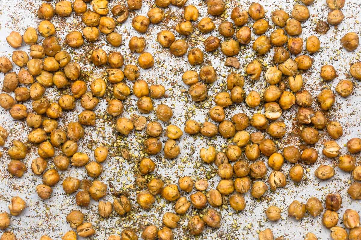 Chickpeas roasted in baking sheet with seasoning