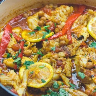 Braised cod fish in pan with Moroccan flavors. Moroccan fish