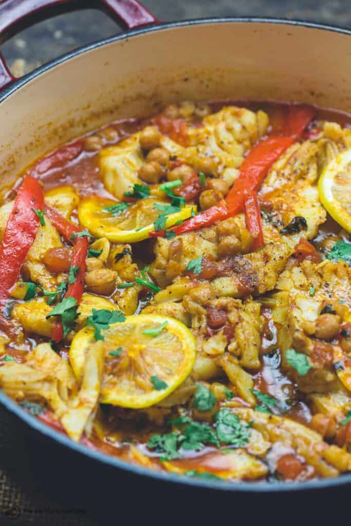 Braised cod fish in pan with Moroccan flavors. Moroccan fish