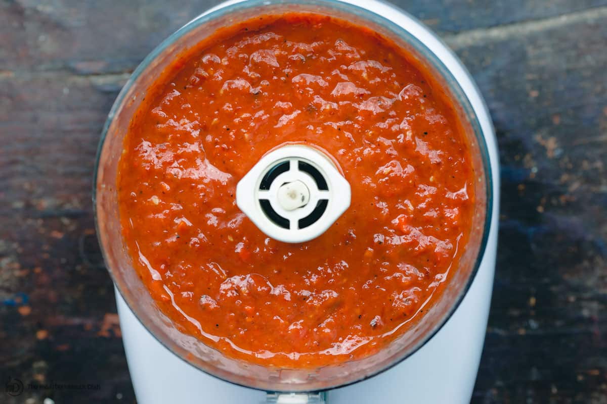 Roasted tomatoes and carrots blended in food processor to form a creamy base for the tomato basil soup