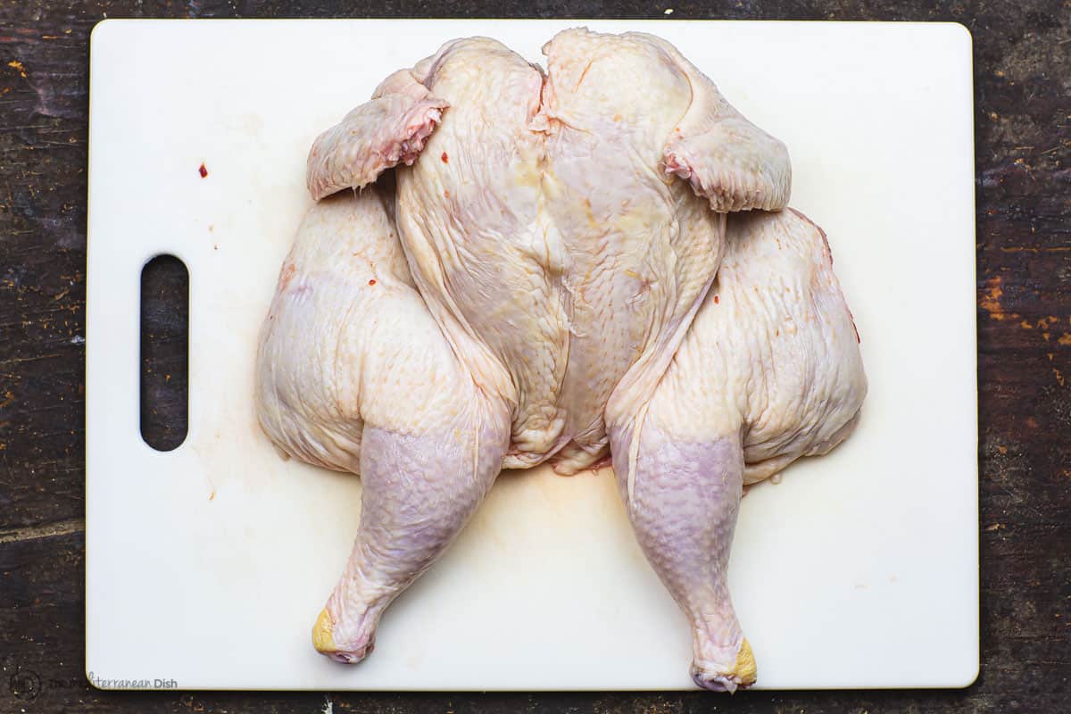 butterflied chicken on cutting board