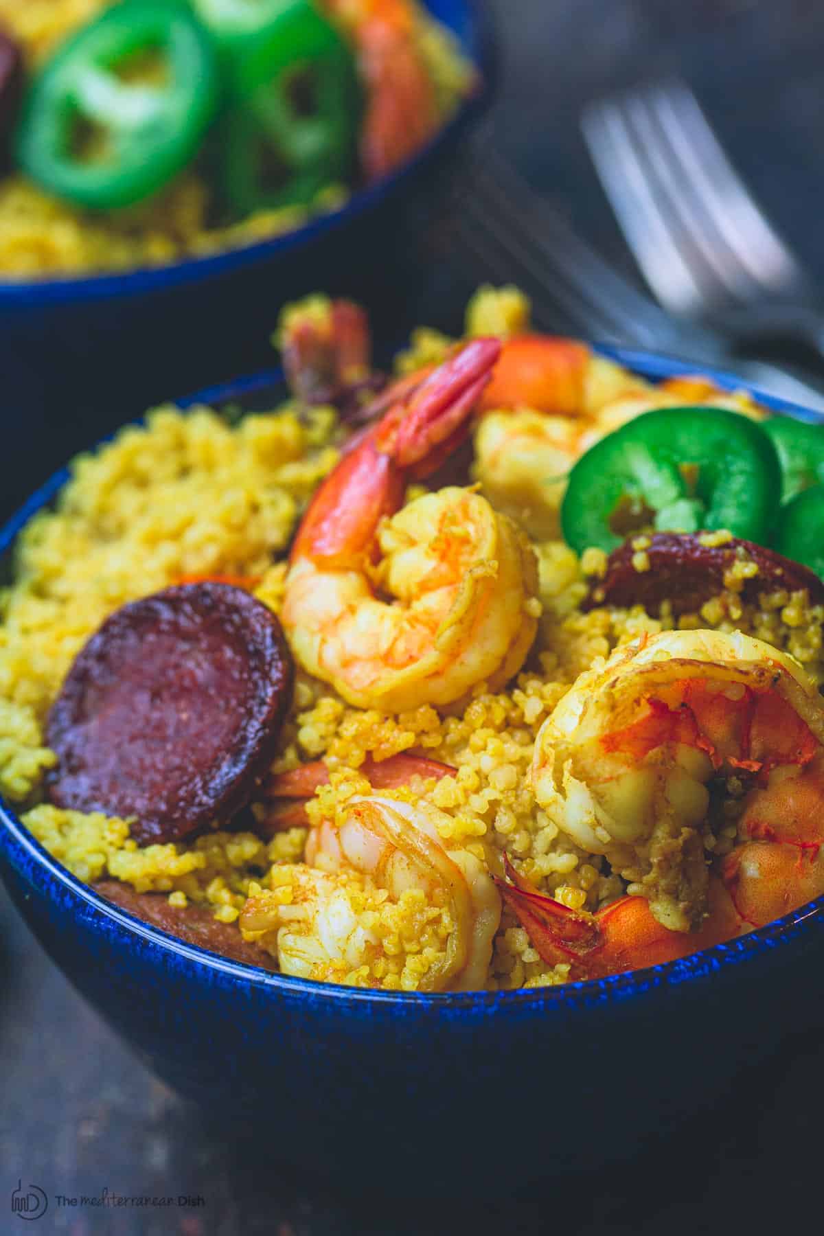 Spicy couscous with shrimp and chorizo in a bowl