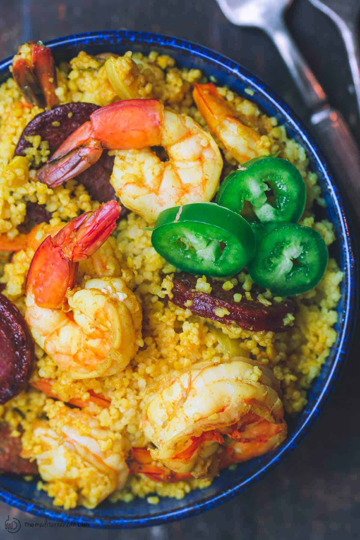 Spicy shrimp with couscous and chorizo in a small bowl