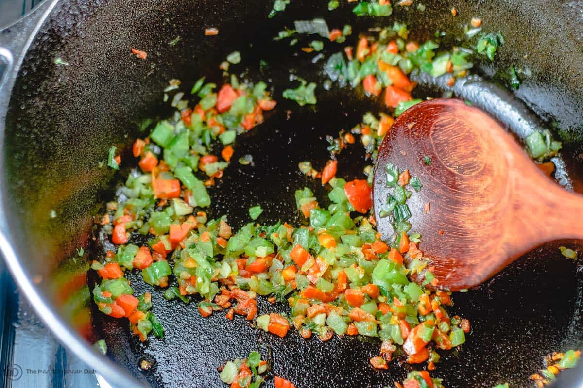 carrots, celery, onions and garlic being cooked in pot