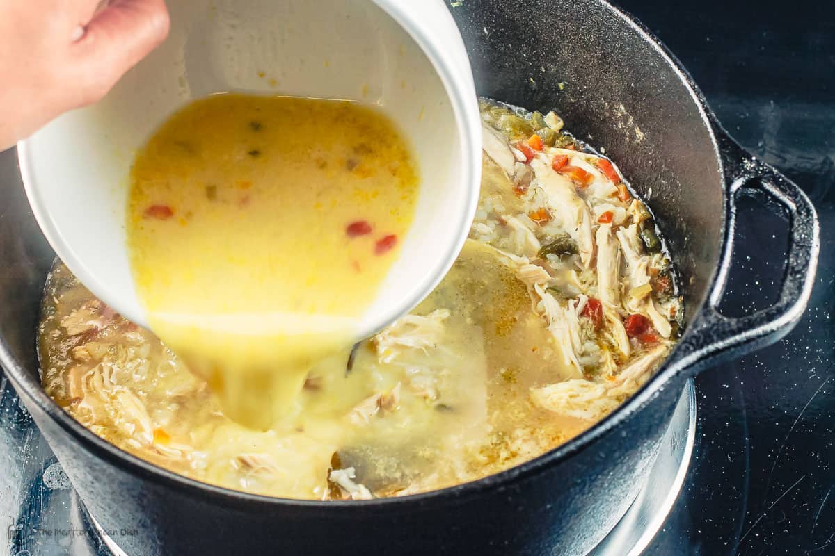 egg lemon sauce being added to chicken soup