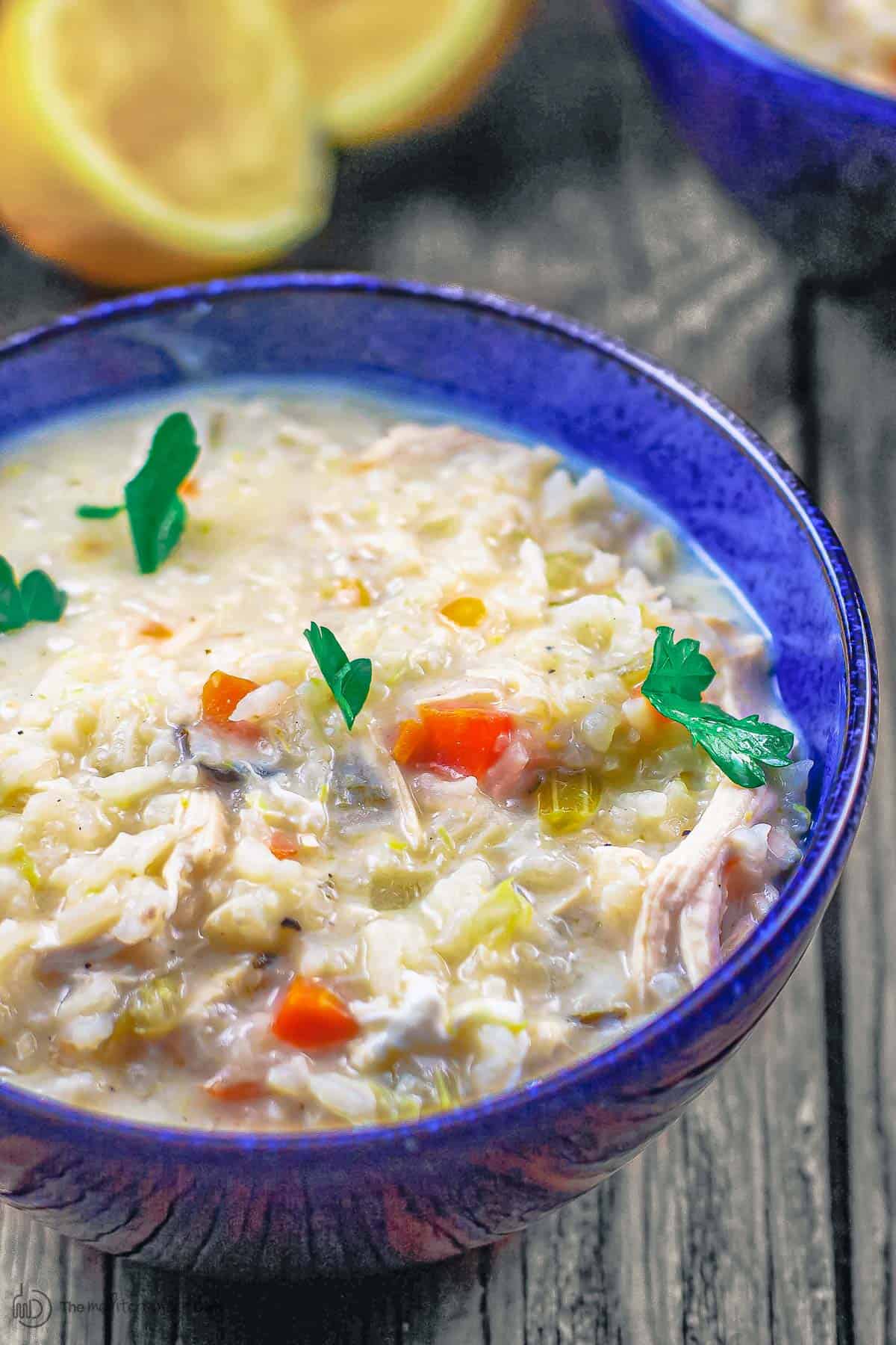 Avgolemono soup served in blue bowl