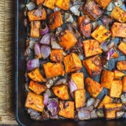 Diced sweet potatoes and onions roasted in cast iron pan