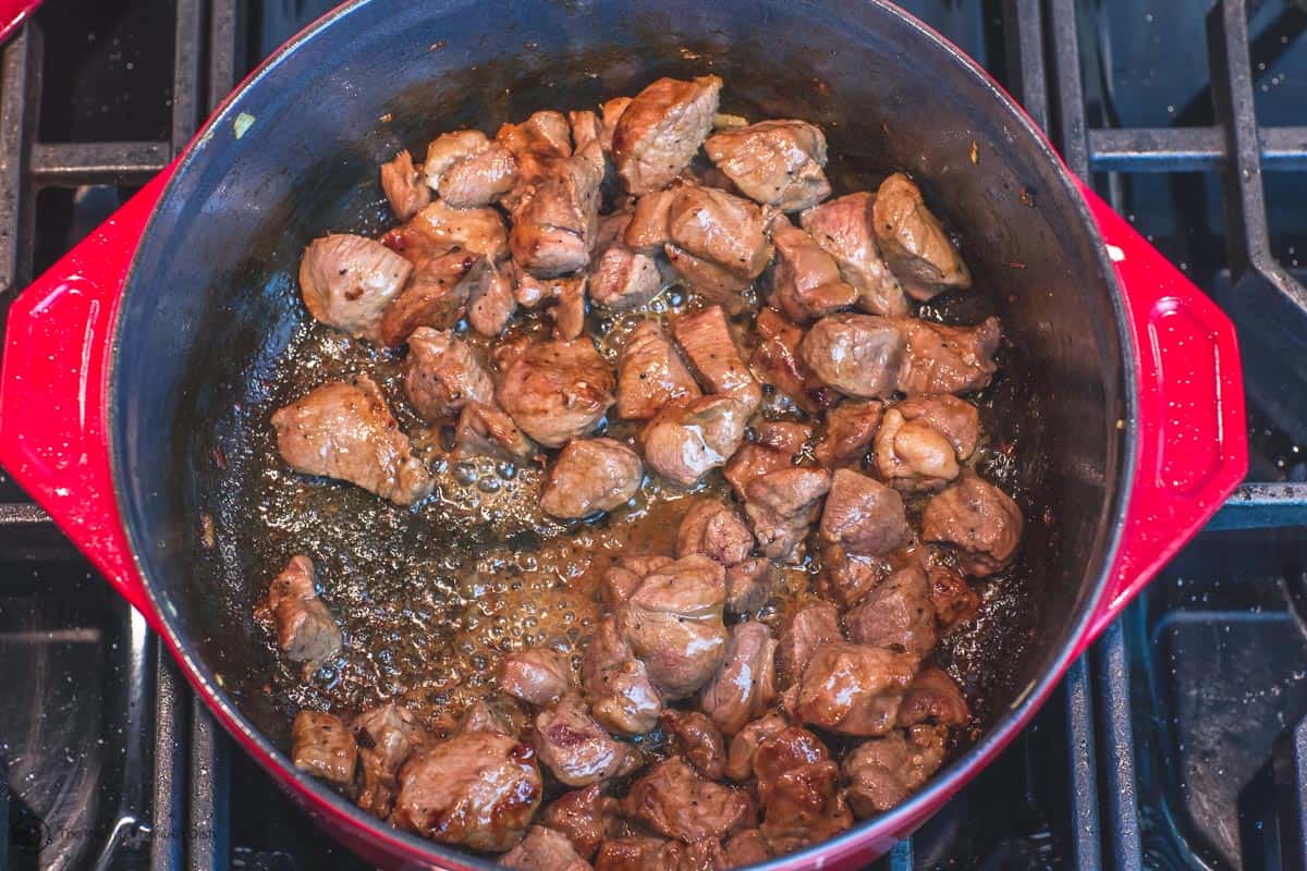 Diced lamb being browned in pot