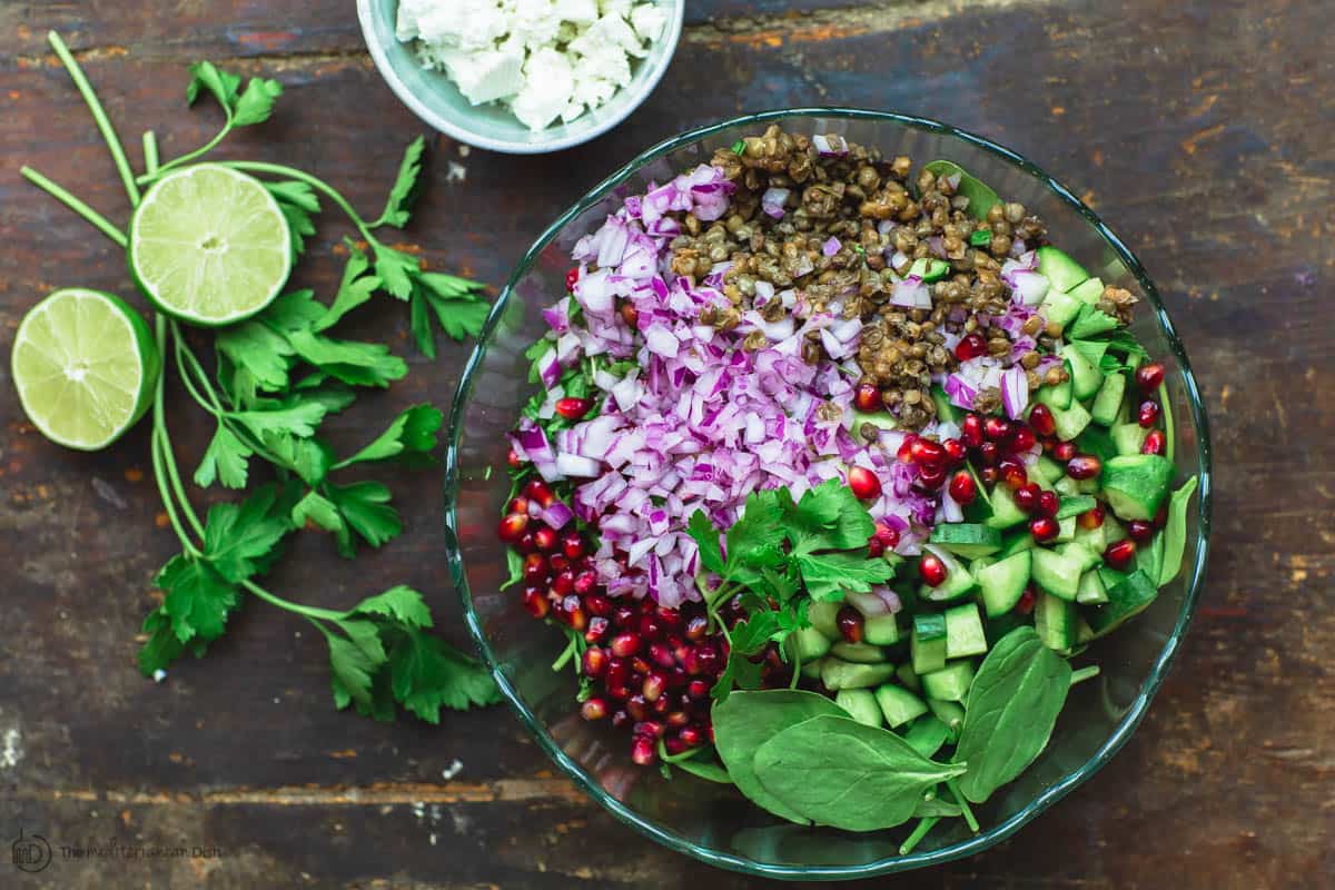 Ingredients for lentil salad in a mixing bowl