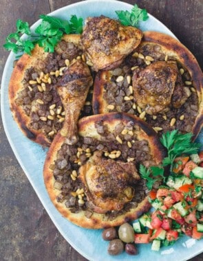 Musakhan sumac chicken over carmalized onion flatbread with side salad