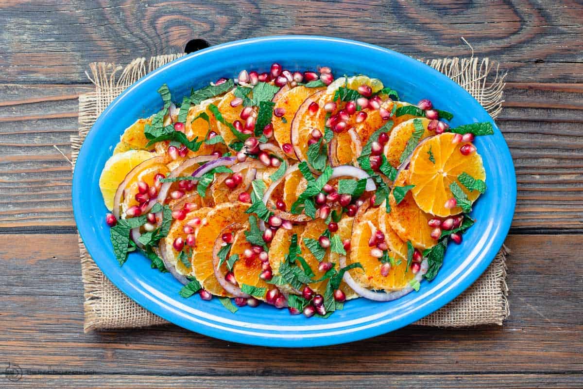 Assembled orange salad on blue platter