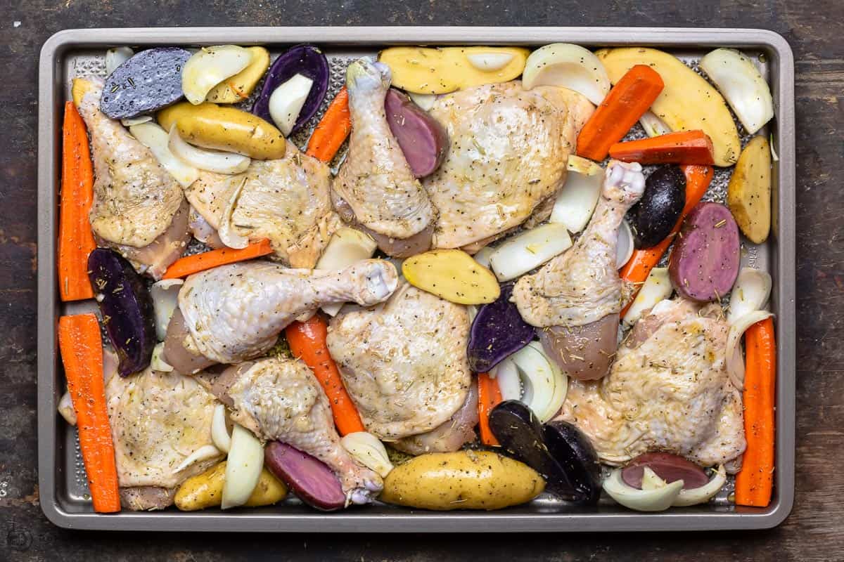 Vegetables and chicken on baking sheet before baking