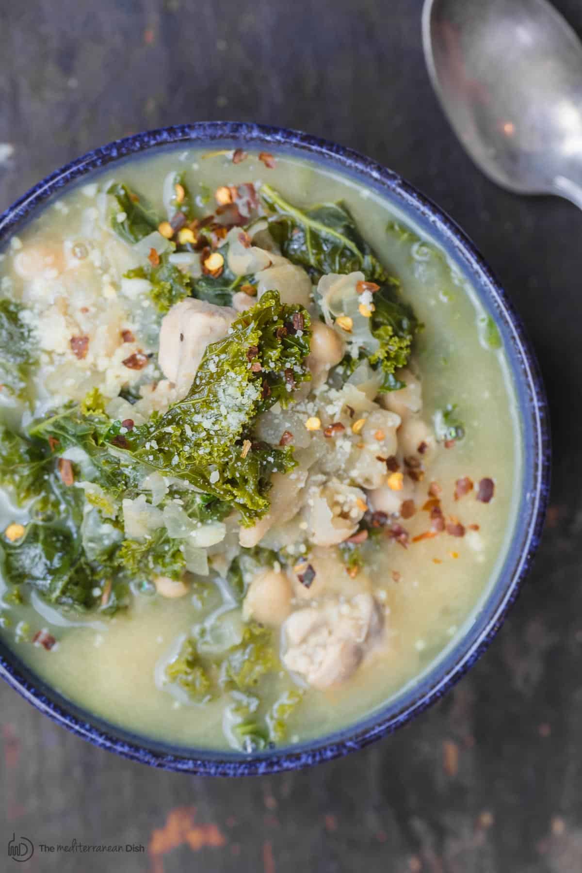 White bean soup served in bowl with a drizzle of olive oil on top