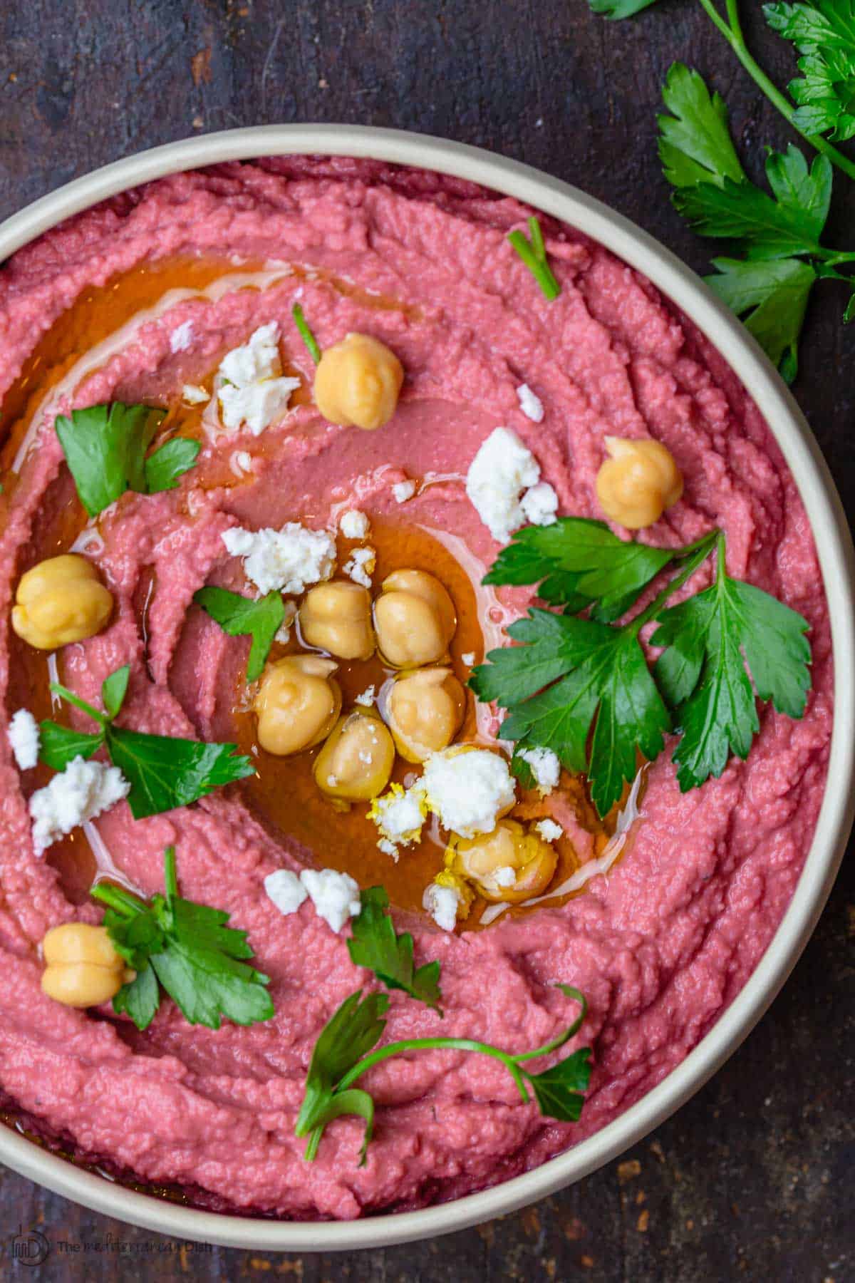Beet Hummus, topped with chickpeas and parsley for garnish