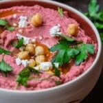 Beet hummus in a bowl served with pita bread