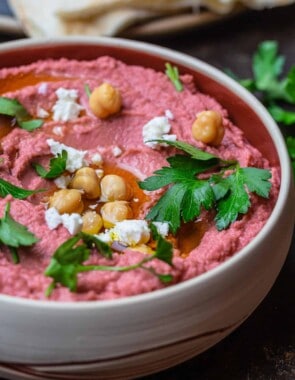 Beet hummus in a bowl served with pita bread