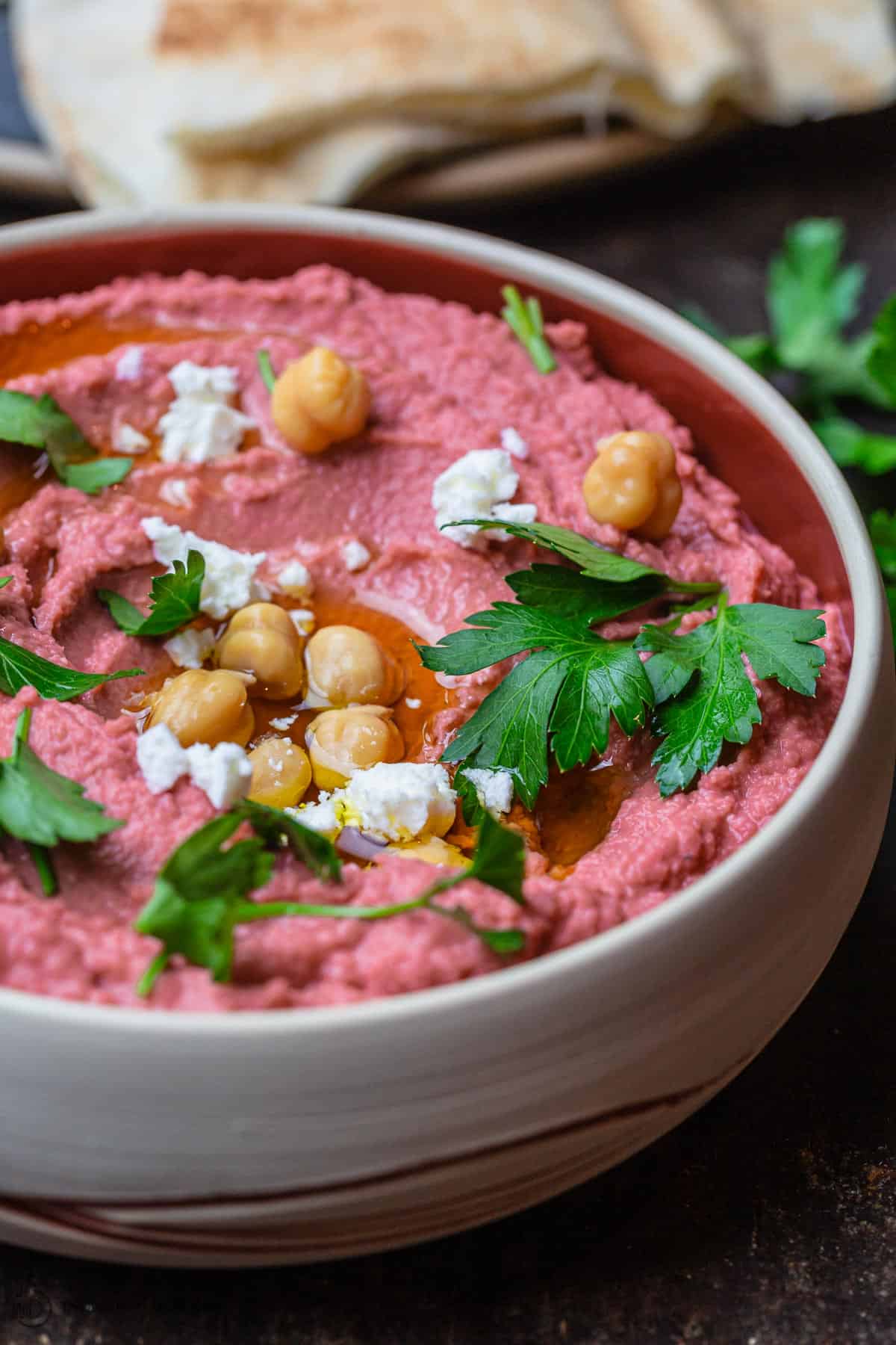 Beet hummus in a bowl served with pita bread