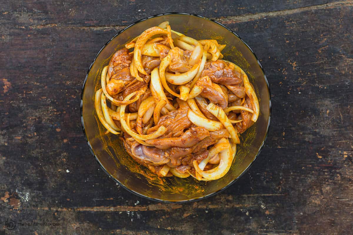 Shawarma chicken marinating in bowl