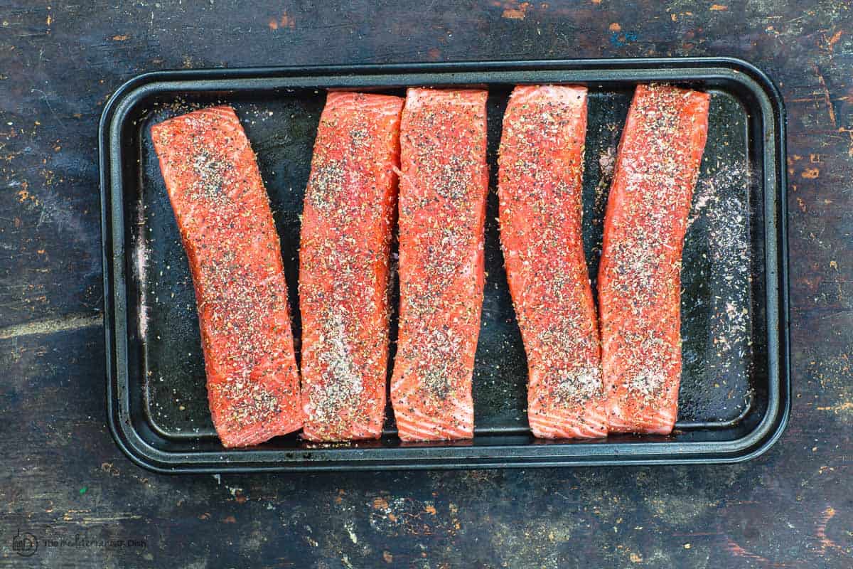 Raw salmon fillets seasoned and ready for searing