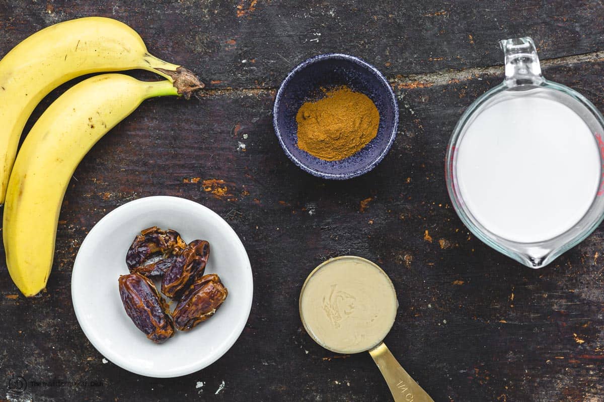 Ingredients for date banana shake. Bananas, almond milk, medjool dates, tahini, and cinnamon