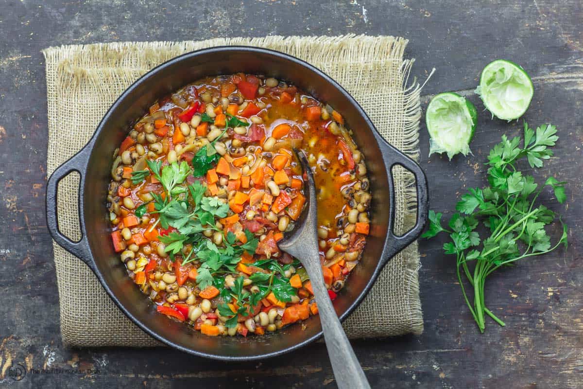 Vegan black eyed peas stew in a pot. Finished with parsley