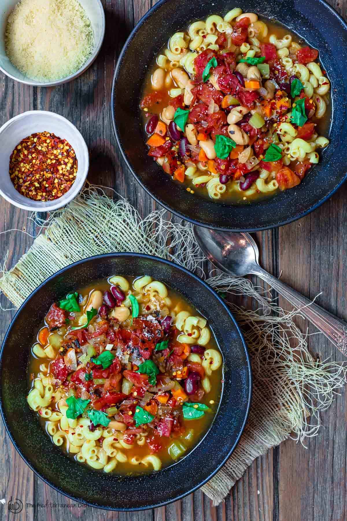 Pasta e fagioli served with a side of grated parmesan