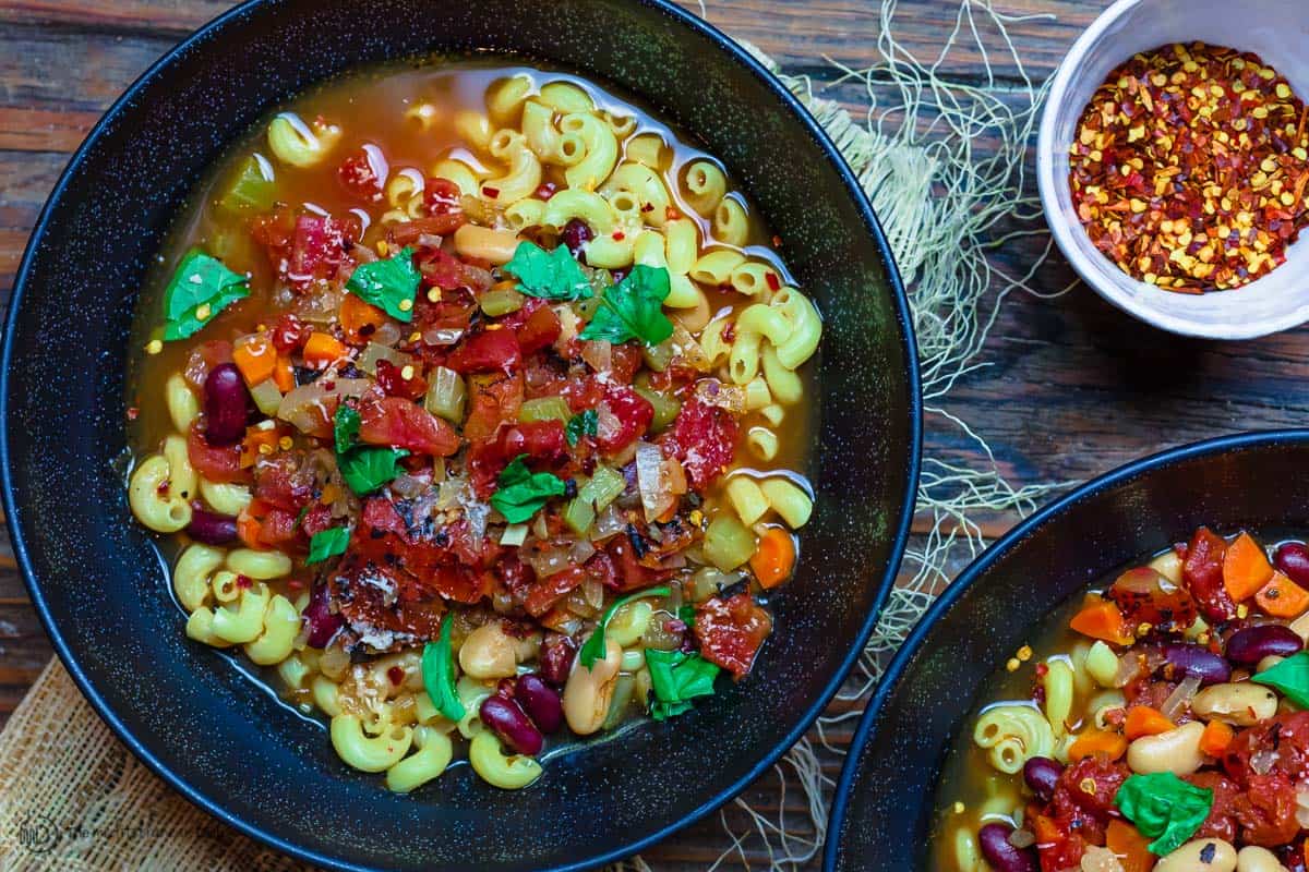 Pasta Fagioli dinner bowls, a side of crushed red pepper flakes