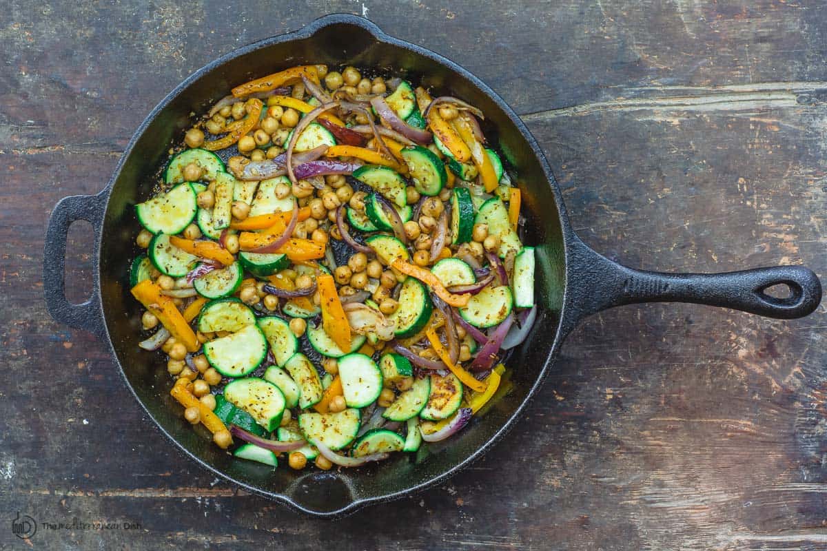 Sauteed vegetable and chickpeas in skillet