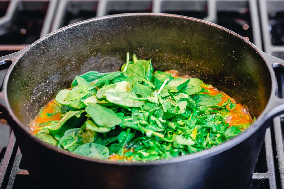 baby spinach is added to sweet potato stew