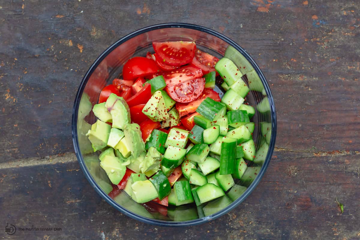 Avocados, tomatoes, and cucumbers in a bowl 