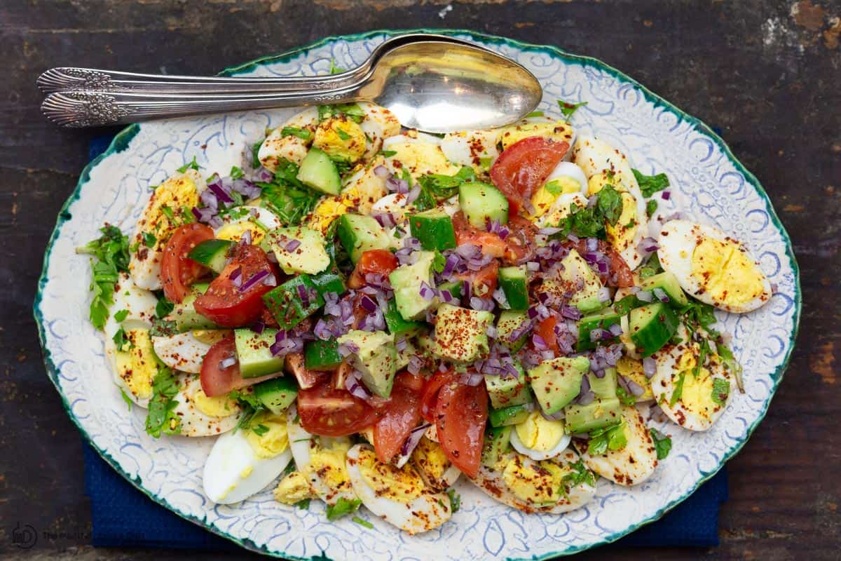 Vegetables added on top of eggs for healthy egg salad