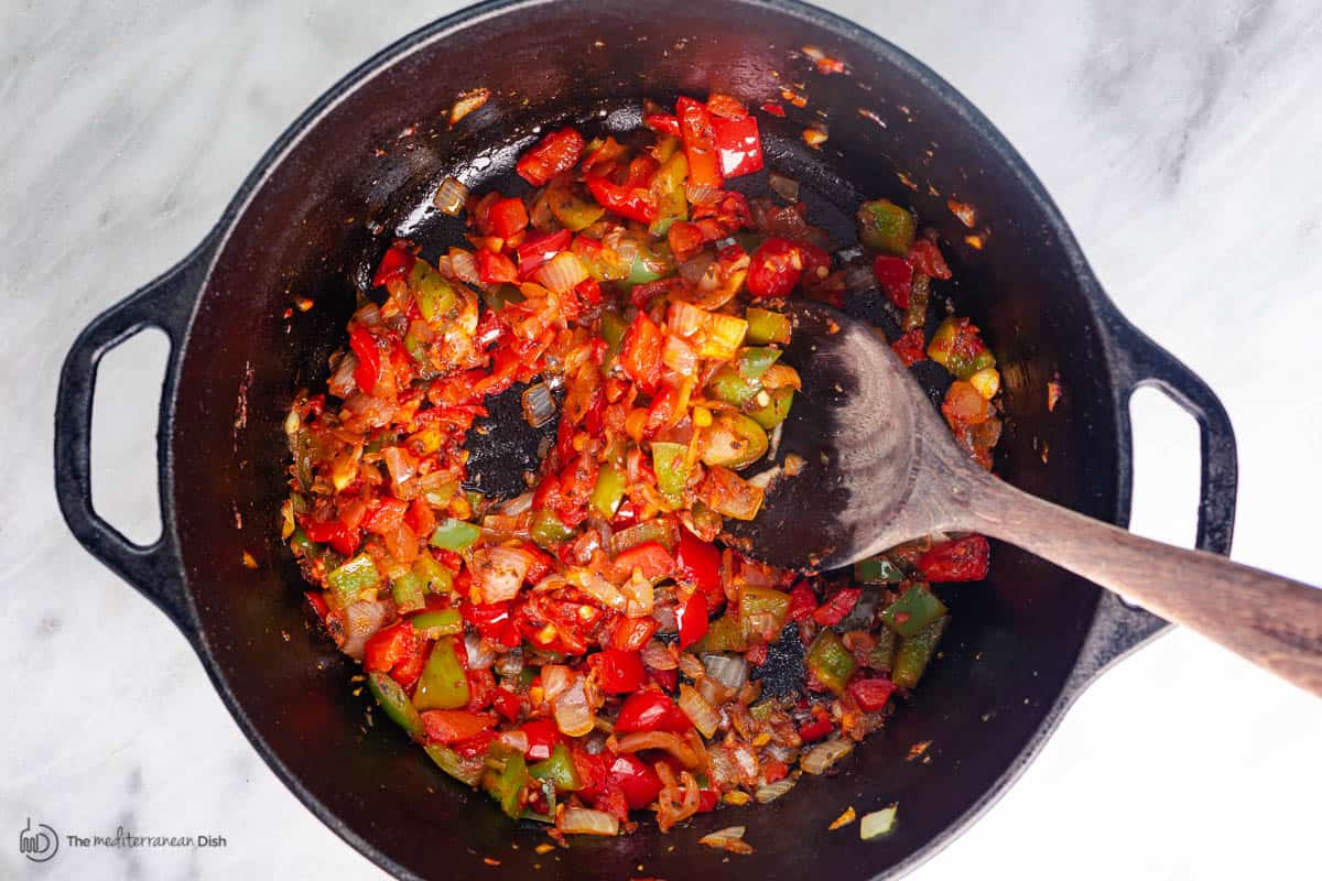 Bell peppers sauted with garlic and onions in a large pot