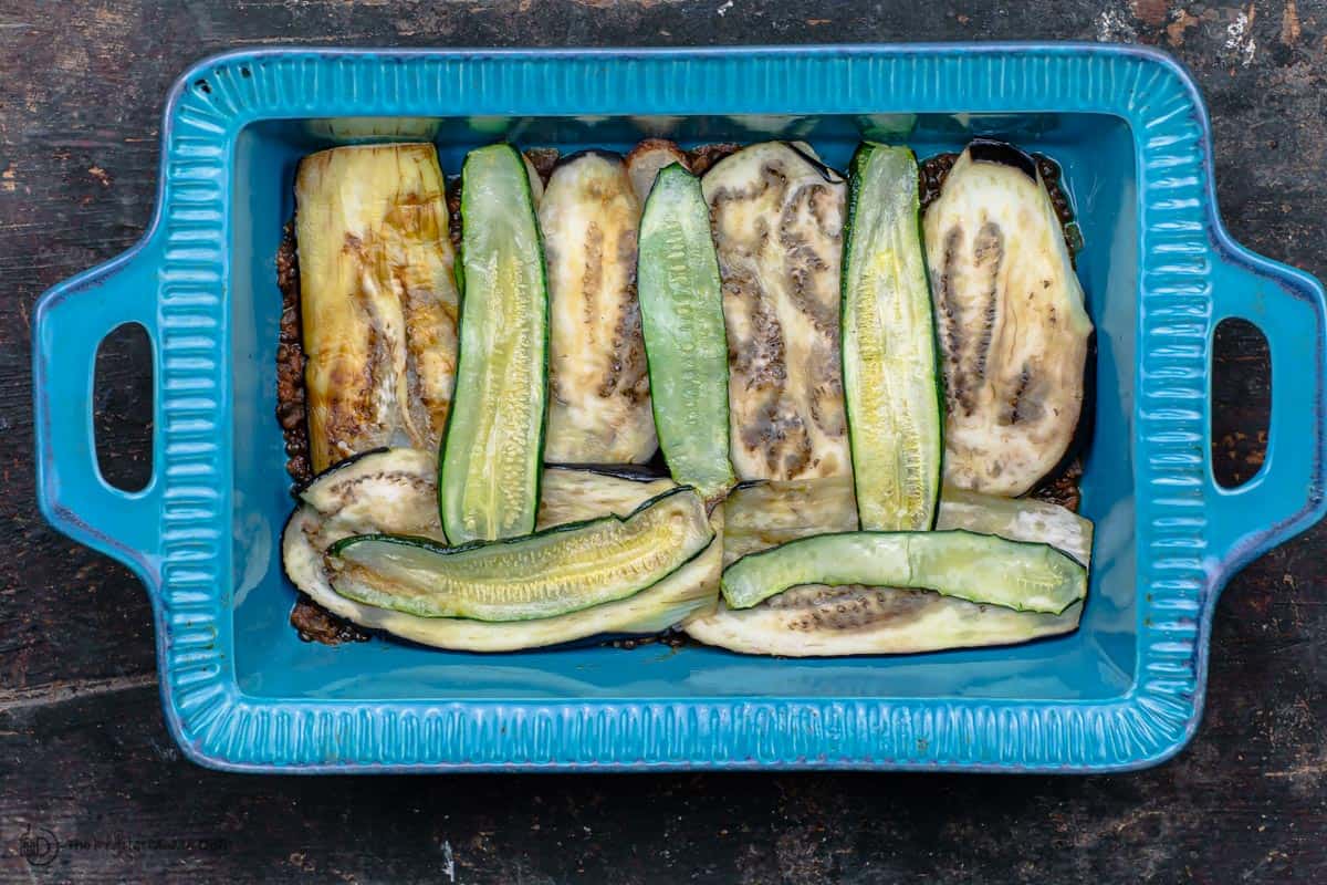 Roasted vegetables layered in baking pan