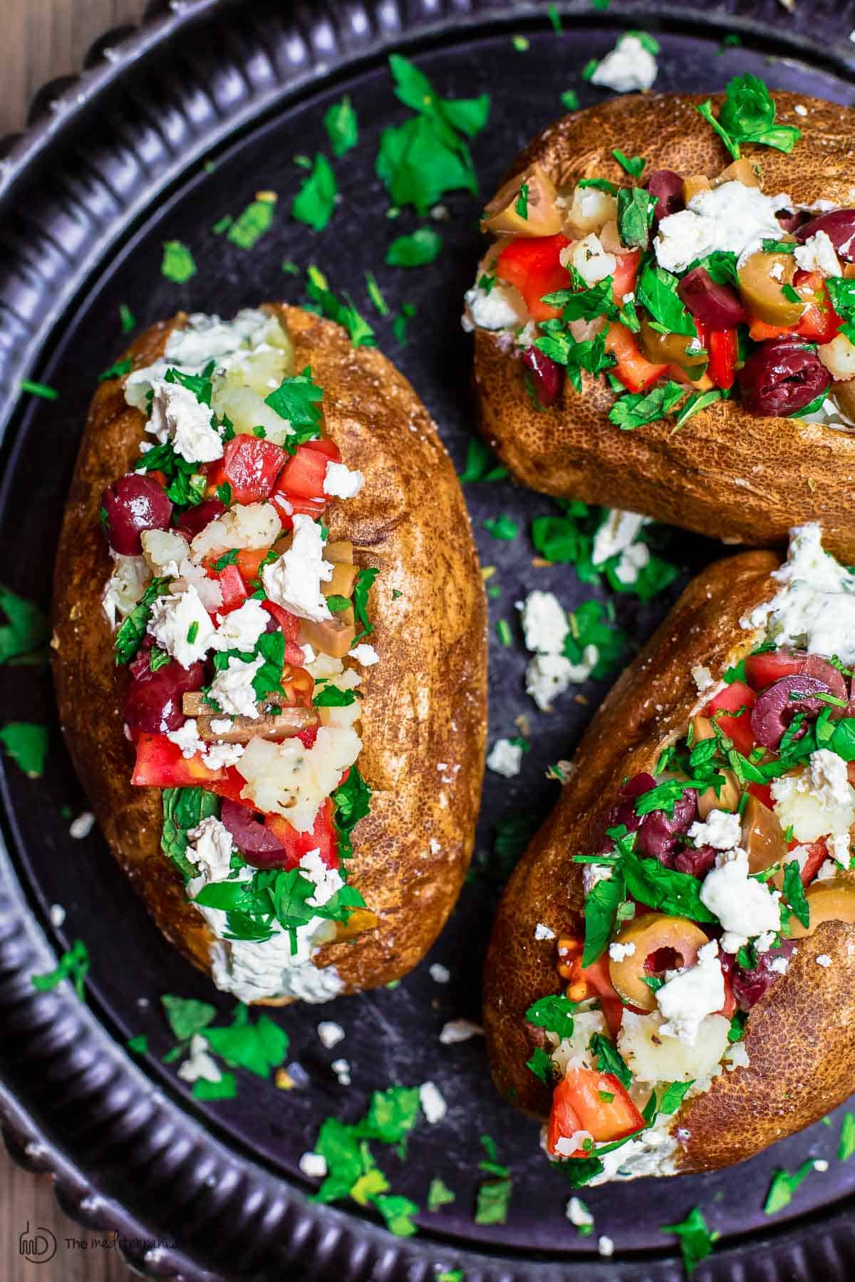 Baked potato, loaded with tztaziki sauce and other Mediterranean toppings