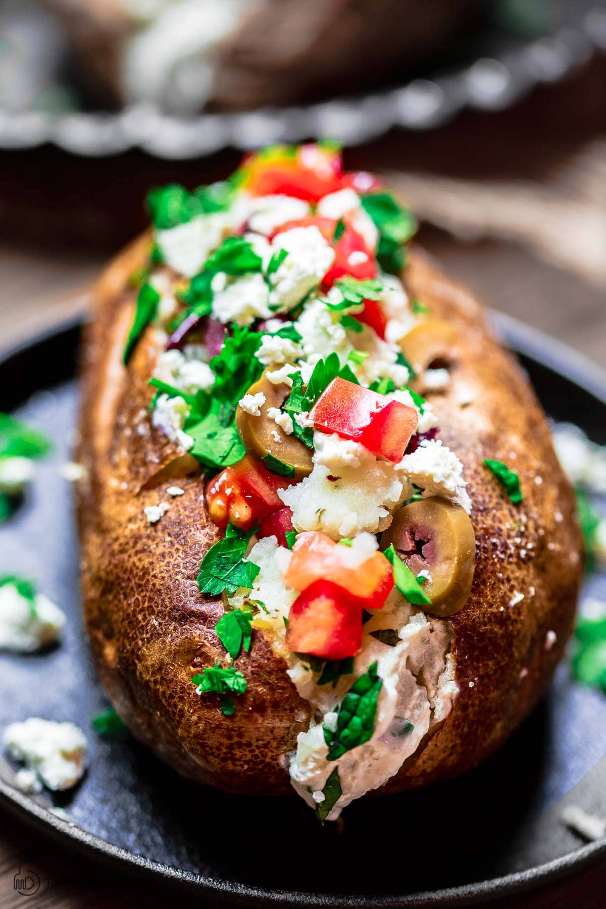 Loaded baked potato with Mediterranean toppings