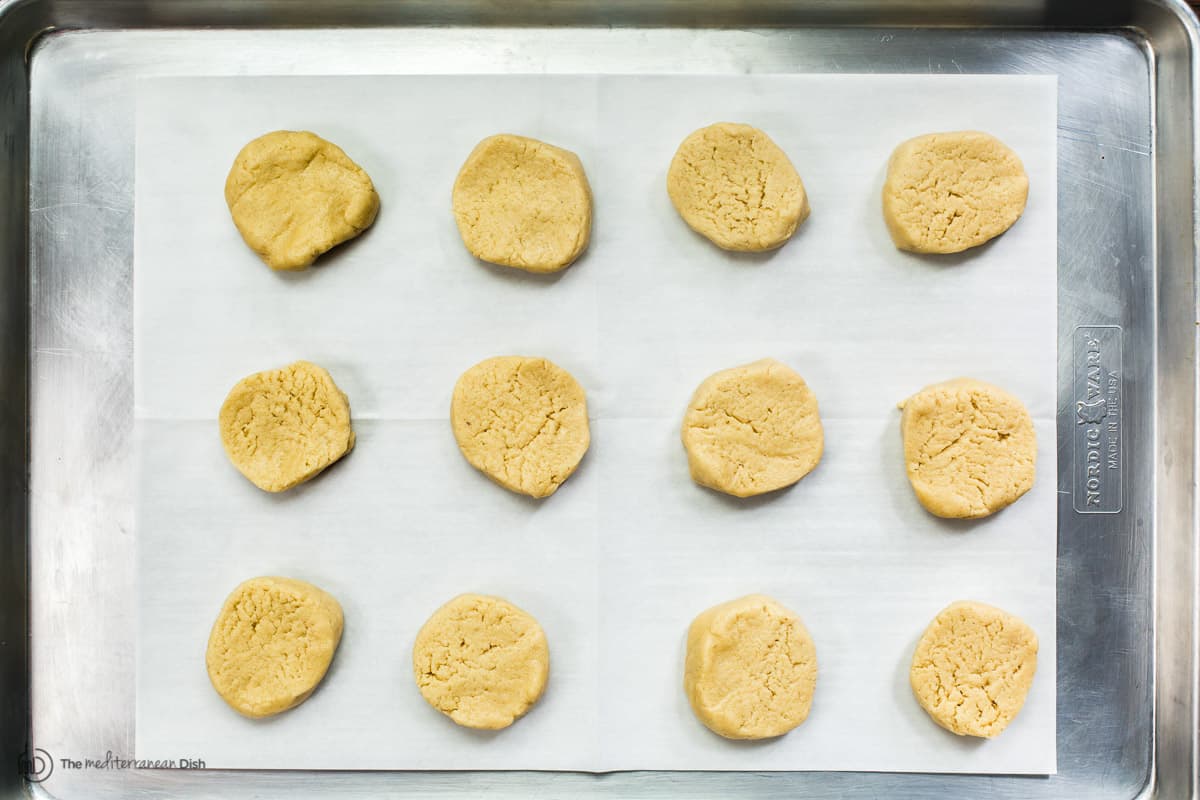  Cookie dough portioned into slices and arranged on a baking sheet